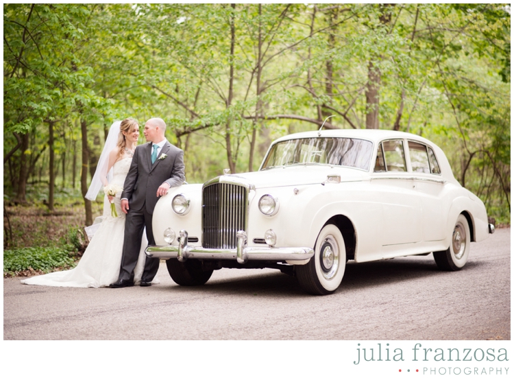 Couple leaves their catholic ceremony in a vintage bentley