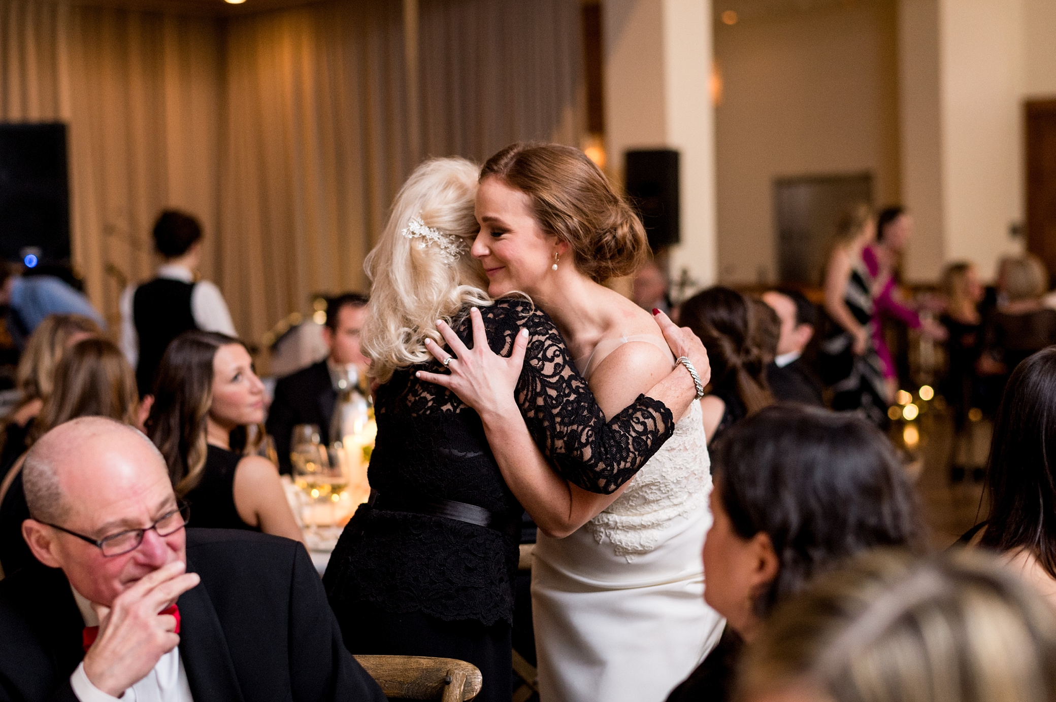 Bride and mother of groom hugging at Ivy Room Wedding